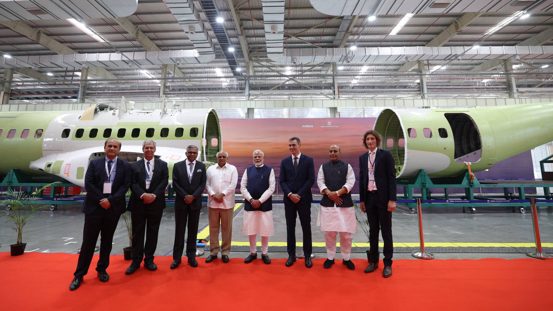 Dignitaries in front of a c295 fuselage