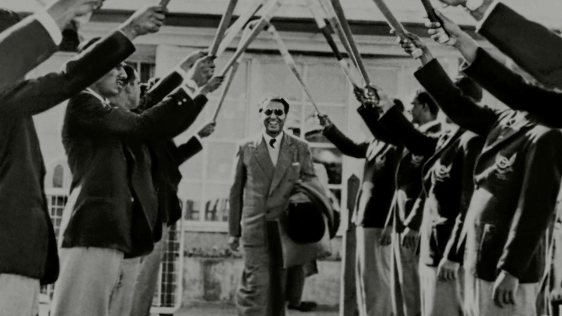 Naval Tata walking under a victory arch of Tata Sports Club hockey players in Nairobi