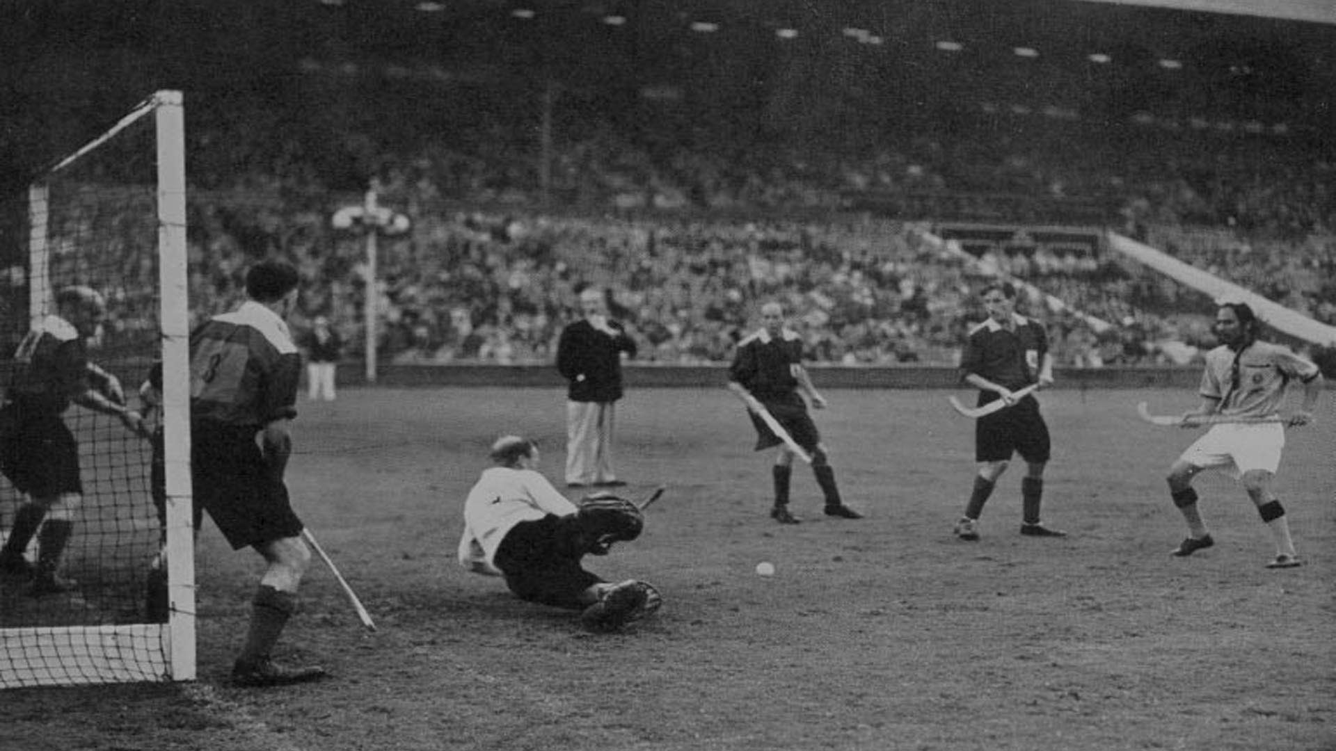 The Indian hockey team scoring the winning goal against Great Britain