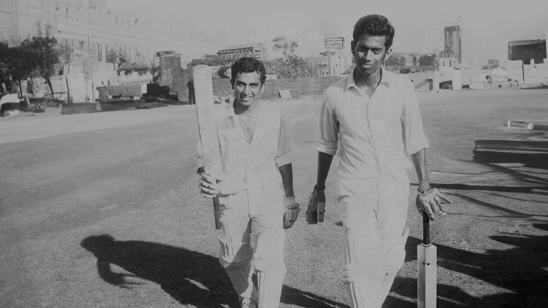 Milind Rege and Sunil Gavaskar walking back after a successful innings