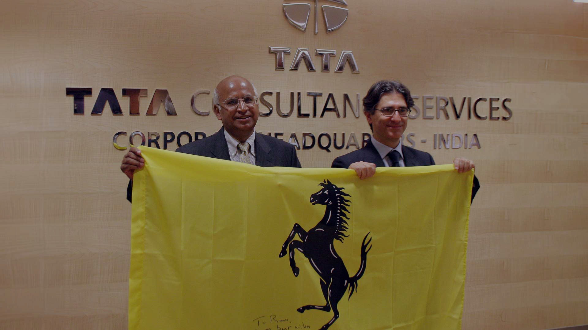 Then CEO S Ramadorai and Ferrari CIO Antonio Calabrese with an autographed Ferrari flag